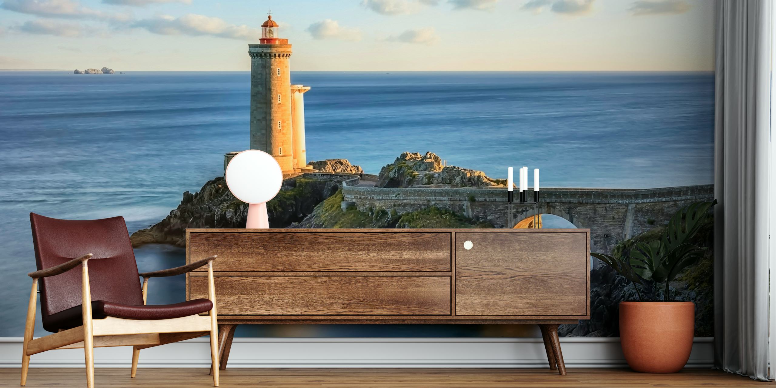A lighthouse by the sea during sunset, featuring warm tones and calm water wallpaper